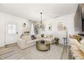 Bright living room featuring an elegant chandelier, cozy seating, and stylish decor at 7239 Governors Row, Avon, IN 46123