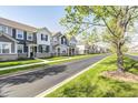 Scenic street view showcasing well-maintained townhomes and a beautifully landscaped boulevard at 7239 Governors Row, Avon, IN 46123