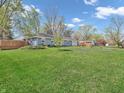 Landscaped side yard featuring a well-maintained lawn and decorative fencing creates a welcoming outdoor space at 7671 Sherry Ln, Brownsburg, IN 46112