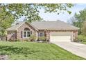Beautiful brick house with an attached garage, a well-maintained lawn, and an inviting front entrance at 768 Grace Ct, Carmel, IN 46032