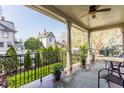 Inviting covered porch with stone floors, potted plants, and a view of the landscaped neighborhood at 902 N College Ave, Indianapolis, IN 46202