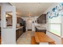 Well-lit kitchen with granite counters, dark cabinets, and eat in dining space, perfect for casual dining at 10820 Washington Bay Dr, Fishers, IN 46037