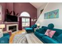 Spacious living room features hardwood floors, plush seating, fireplace and lots of light at 10820 Washington Bay Dr, Fishers, IN 46037