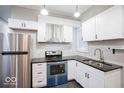 The modern kitchen features granite countertops, stainless steel appliances, and ample cabinetry for storage and functionality at 117 W Arizona St, Indianapolis, IN 46225
