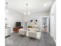 An inviting living area with neutral tones, complemented by modern furniture and stylish decor, creating a welcoming space at 117 W Arizona St, Indianapolis, IN 46225