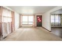Inviting living room with a large window, neutral carpet, and ample natural light at 1507 Lynnwood Dr, Anderson, IN 46012