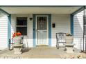 Inviting front porch featuring rocking chairs and planters, creating a warm and welcoming entry to the home at 1510 Asbury St, Indianapolis, IN 46203