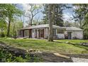 Charming single story brick home with white painted brick and mature trees at 157 E 61St St, Indianapolis, IN 46220