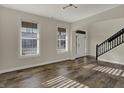 Spacious living area boasts hardwood floors, large windows, and elegant staircase at 16271 Ambia Cir, Westfield, IN 46074