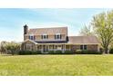 Traditional two-story house with brick accents, complemented by well-maintained landscaping and a spacious lawn at 1652 Valley Brook Dr, Indianapolis, IN 46229