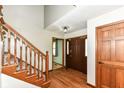Welcoming foyer showcasing hardwood floors, a staircase, and a view into other living spaces at 1652 Valley Brook Dr, Indianapolis, IN 46229