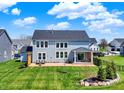 Spacious backyard featuring a well-maintained lawn and a cozy patio area at 16683 Alex Dr, Noblesville, IN 46060