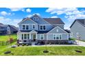 Charming two-story home featuring a covered front porch and well-manicured lawn at 16683 Alex Dr, Noblesville, IN 46060