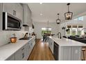 Bright, open kitchen featuring quartz countertops, stainless appliances, and a view to the dining area at 16683 Alex Dr, Noblesville, IN 46060