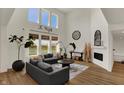 Bright living room with vaulted ceilings, large windows, and stylish modern decor at 16683 Alex Dr, Noblesville, IN 46060