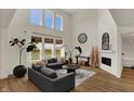 Inviting living room with soaring ceilings, large windows, and a cozy fireplace at 16683 Alex Dr, Noblesville, IN 46060