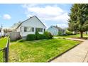 Charming home with well-maintained lawn and beautiful landscaping at 1865 N Norfolk St, Indianapolis, IN 46224