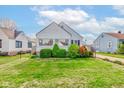 Well-maintained house with manicured front lawn on a sunny day at 1865 N Norfolk St, Indianapolis, IN 46224