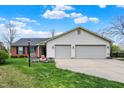 Attractive single-story home with a brick facade, two-car garage, well-maintained lawn, and mature trees at 20777 Summitt Rd, Noblesville, IN 46062