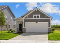Charming single-Gathering home showcases a gray exterior, stone accents, and a spacious two-car garage at 2276 Marjorie Way, Shelbyville, IN 46176