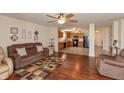 Inviting living room with hardwood floors, comfortable seating, and a seamless flow to the kitchen at 2923 Armaugh Dr, Brownsburg, IN 46112
