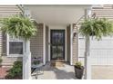 Welcoming front entrance adorned with lush ferns and a cozy welcome mat at 3189 Underwood Dr, Whiteland, IN 46184