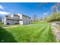 Expansive back yard with a grassy lawn and patio perfect for outdoor entertaining at 3611 Owster Ln, Indianapolis, IN 46237