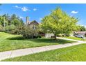 Charming home features a well-manicured lawn, mature tree, and inviting curb appeal on a sunny day at 3611 Owster Ln, Indianapolis, IN 46237