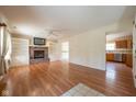 Spacious living room featuring hardwood floors, a brick fireplace, and built-in shelving at 3611 Owster Ln, Indianapolis, IN 46237