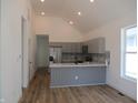 Open kitchen with grey cabinets, stainless appliances, backsplash and hardwood flooring at 4230 Kingsley Dr, Indianapolis, IN 46205