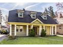 Charming exterior featuring well-manicured lawn and covered front porch at 4247 Central Ave, Indianapolis, IN 46205