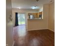 View of an open-concept floor plan with kitchen, living, and dining areas connected by sleek, modern flooring at 4932 Tuscany Ln, Indianapolis, IN 46254