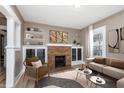Cozy living room featuring a brick fireplace, built-in shelving, and neutral decor at 5074 E Walnut St, Indianapolis, IN 46201