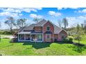 Elegant brick house with a welcoming porch, offering a blend of classic design and outdoor comfort at 5299 W Pr Black Hawk, Edinburgh, IN 46124