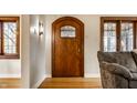 Elegant foyer featuring a wooden front door, hardwood floors, and charming architectural details at 5331 N New Jersey St, Indianapolis, IN 46220