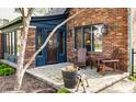 Inviting front porch with brick accents, a seating area, and well-manicured landscaping at 5331 N New Jersey St, Indianapolis, IN 46220