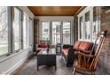 Bright and airy sunroom with large windows, brick walls, and cozy seating area at 5331 N New Jersey St, Indianapolis, IN 46220