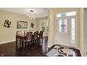 Formal dining room featuring dark hardwood floors, modern lighting, and a decorative wall mirror at 5549 Dill Ct, Indianapolis, IN 46237