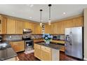 Spacious kitchen with stainless steel appliances, granite countertops, and wood cabinetry at 5549 Dill Ct, Indianapolis, IN 46237