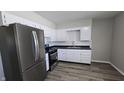 Stylish kitchen boasts stainless steel appliances, white cabinets, and a modern gas range at 5636 W Henry St, Indianapolis, IN 46241