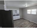 Bright kitchen with white cabinets, black countertops, and stainless steel sink under a window at 5636 W Henry St, Indianapolis, IN 46241