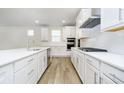 Well-lit kitchen with a large island, updated appliances, and a gas stovetop at 5661 Stetson Dr, Whitestown, IN 46052