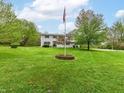 Attractive two-story house featuring a well-maintained front lawn and flagpole at 6113 N 250 E, Greenfield, IN 46140