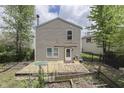 Exterior back view of a home featuring a weathered wooden deck and a view of the yard at 6534 Redland Way, Indianapolis, IN 46217