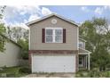 Charming two-story home featuring a front-facing two car garage and a well-manicured lawn at 6534 Redland Way, Indianapolis, IN 46217