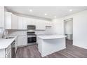 Modern kitchen featuring a stainless steel range, built-in microwave, and white countertops at 6801 Seabiscuit Rd, Whitestown, IN 46075
