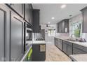 Modern kitchen features sleek, gray cabinetry, recessed lighting, stainless steel appliances and marble countertops at 7104 Combs Rd, Indianapolis, IN 46237