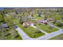 Expansive aerial view of the property showcasing its spacious lot, mature trees and neighborhood at 7114 Hickory Rd, Indianapolis, IN 46259