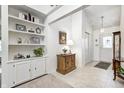 Inviting entryway with built-in shelving, neutral tones, and a view of the front door at 7114 Hickory Rd, Indianapolis, IN 46259