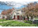 Well-maintained townhome exterior with brick accents, front porch swing, and lovely landscaping at 720 Bucksport Ln, Westfield, IN 46074